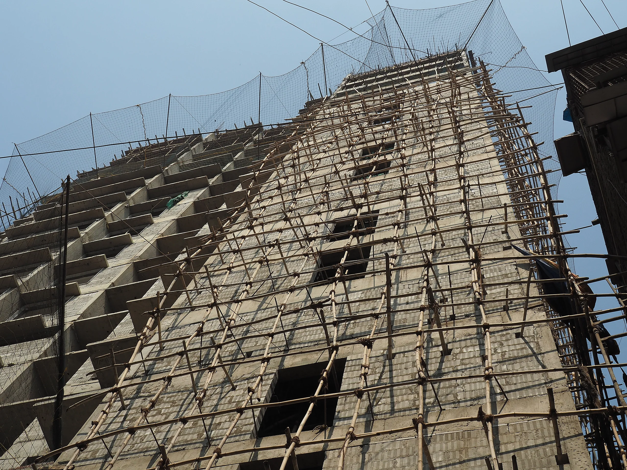 Residential tower under construction with scaffolding in India
